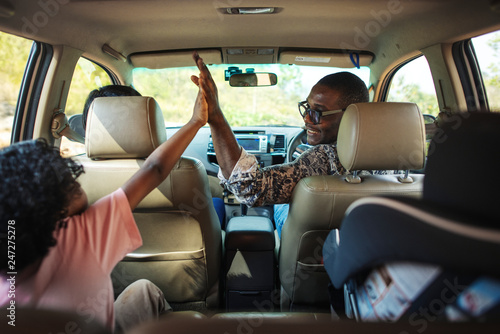 Cheerful family in a car on a road trip