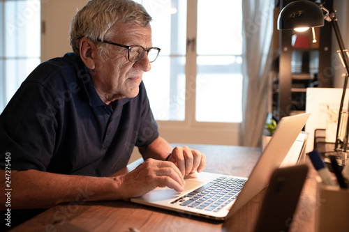 Wallpaper Mural Senior man working on a laptop Torontodigital.ca