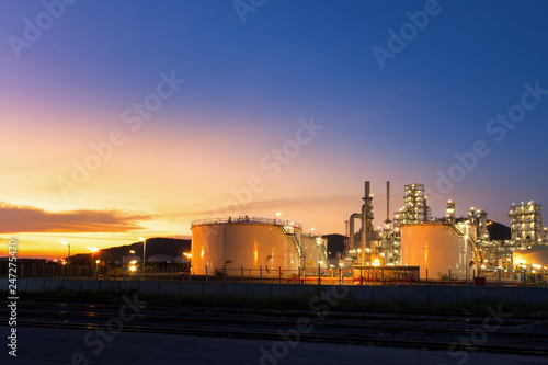 Big industrial oil tanks in a petrochemical plant at sunset