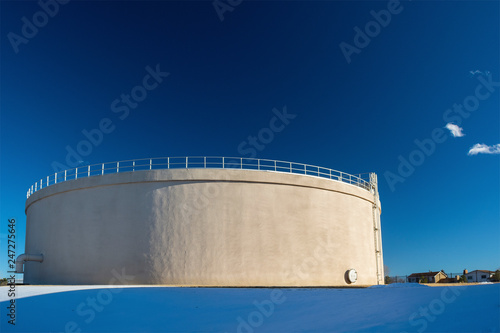 Giant Municipal City Water Tank on a Sunny, Clear Day with Snow