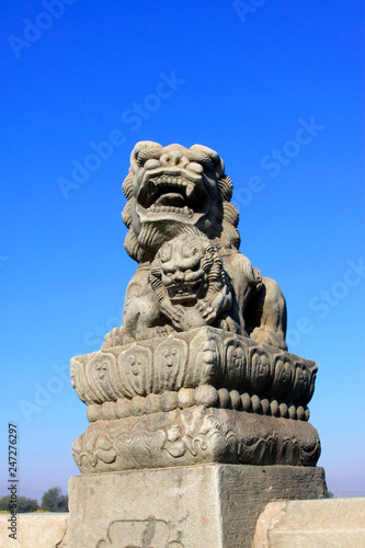 stone lion on bridge railing, China © zhang yongxin
