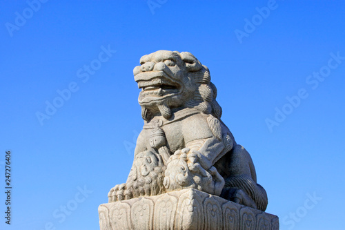 stone lion on bridge railing, China © zhang yongxin