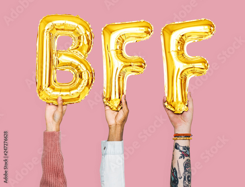 Hands holding BFF word in balloon letters