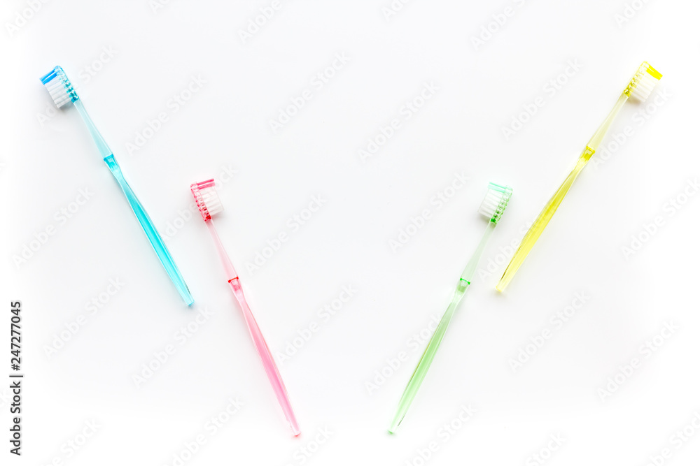 Clean teeth. Colorful plastic toothbrushes on white background top view space for text