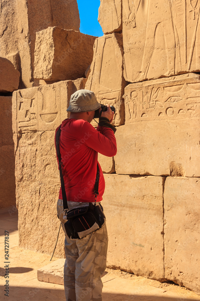 Tourist taking a photos of Karnak temple in Luxor, Egypt