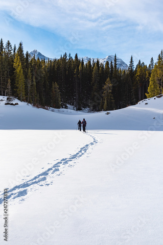 Snowshoeing across a frozen lake
