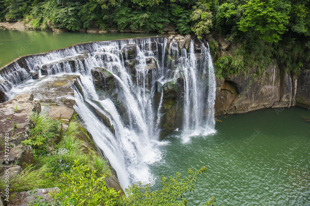 Shifen Waterfall is a scenic waterfall located in Pingxi District, New Taipei City, Taiwan, on the upper reaches of the Keelung River.