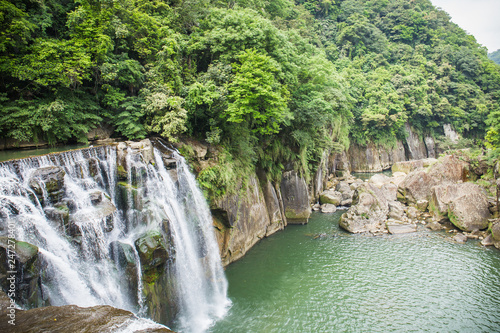 Shifen Waterfall is a scenic waterfall located in Pingxi District, New Taipei City, Taiwan, on the upper reaches of the Keelung River. photo