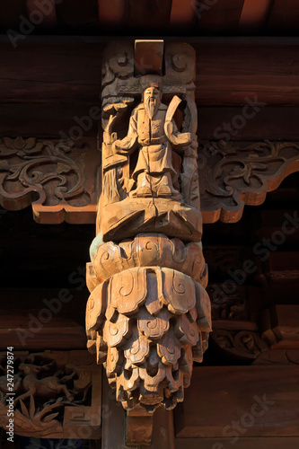 carved figures in front of the door