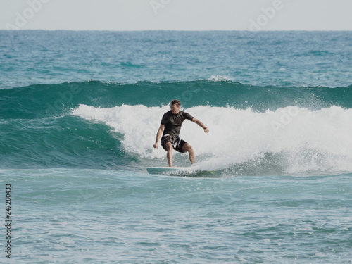 Surfer on blue Atlantic Ocean wave. Tropical winter.  Shortboard.