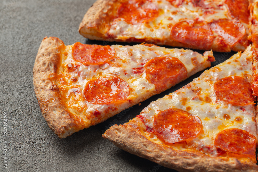 Tasty pepperoni pizza on brown concrete background Tasty pepperoni pizza on brown concrete background