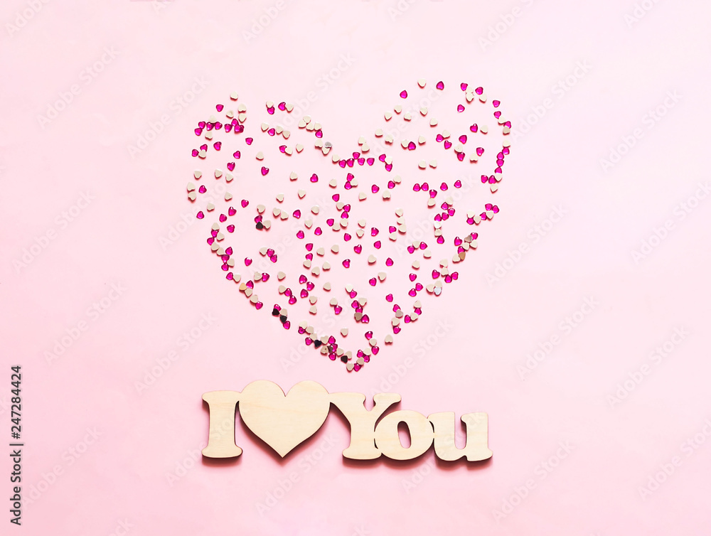 Festive pink background with spangles in the shape of heart. Concept Valentines Day or Mothers Day.
