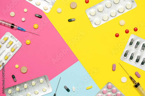 Bright background with copy space in the middle formed with different medication and pillows	