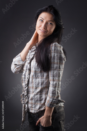 Beautiful sexy lady fashion pretty woman model pose wear plaid shirt and jeans on the Gray studio background