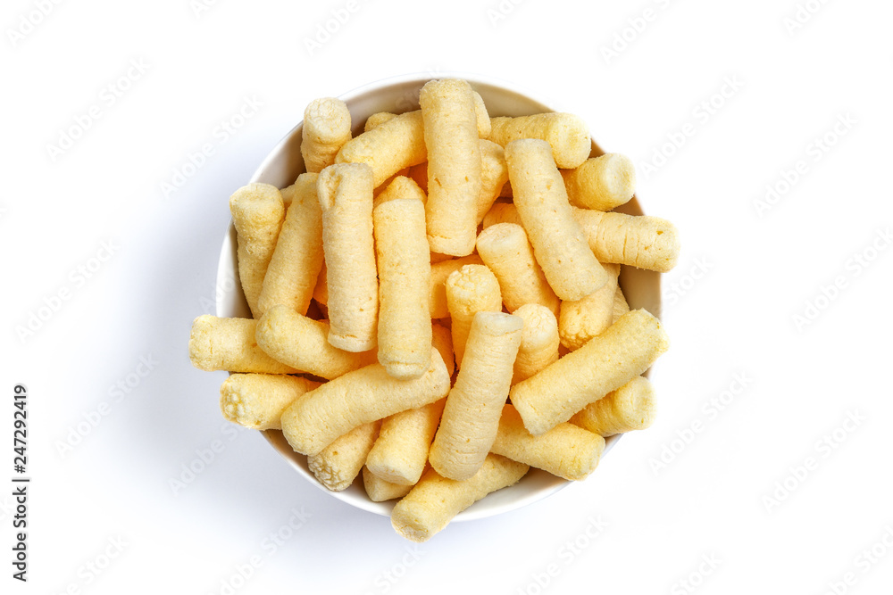 Crunchy corn puffs, pufuleti on bowl isolated over white Crunchy corn puffs, pufuleti on bowl isolated over white