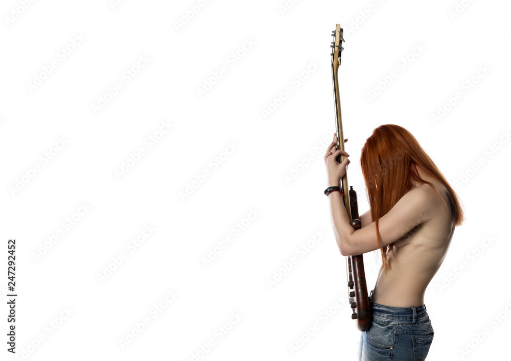 sexy redhead woman holding electric guitar on a white background. rock girl playing on a guitar. free space for text