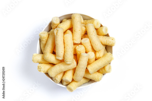 Crunchy corn puffs, pufuleti on bowl isolated over white