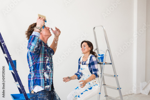 Redecoration, conflict, people and emotions concept - Young woman and man with arguing during renovation in apartment
