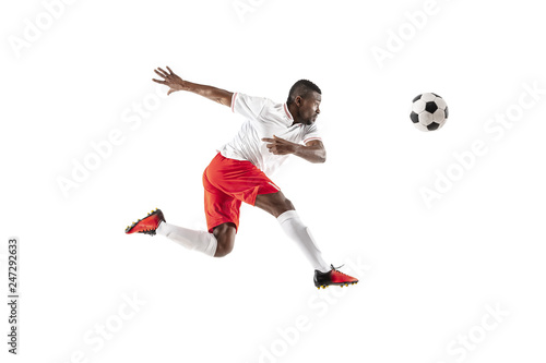 Professional african american football soccer player in motion isolated on white studio background. Fit jumping man in action  jump  movement at game.