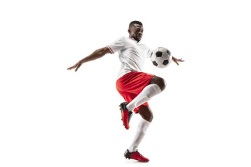 Professional african american football soccer player in motion isolated on white studio background. Fit jumping man in action, jump, movement at game.