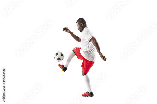 Professional african american football soccer player in motion isolated on white studio background. Fit jumping man in action, jump, movement at game. © master1305