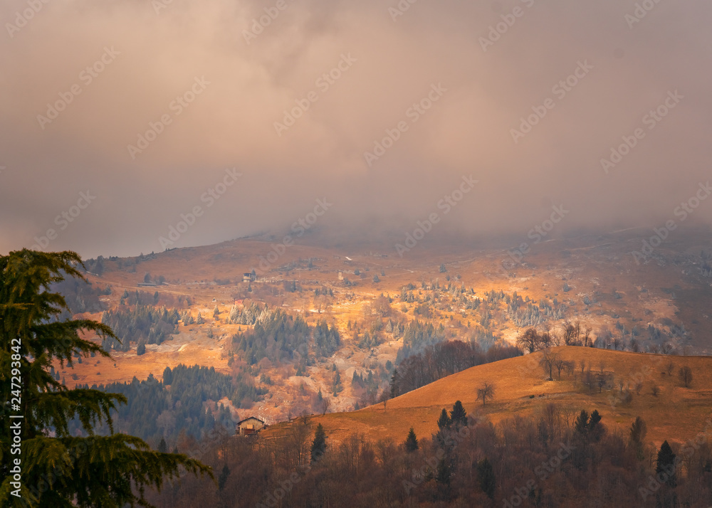 Amazing view of the Orobie Alps, autumn / winter, the mountain is a little snow-covered ,the grass is burned by the cold and turns orange.Oltre il Colle,north alps,Seriana Valley,Bergamo Italy.
