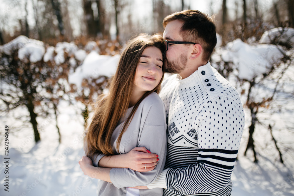 Fototapeta premium Young Beautiful Couple Taking Fun and Smiling Outdoors in Snowy Winter