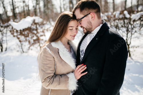 Young Beautiful Couple Taking Fun and Smiling Outdoors in Snowy Winter