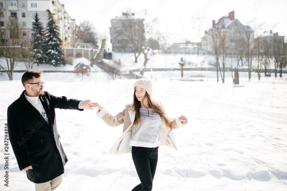 Young Beautiful Couple Taking Fun and Smiling Outdoors in Snowy Winter Young Beautiful Couple Taking Fun and Smiling Outdoors in Snowy Winter