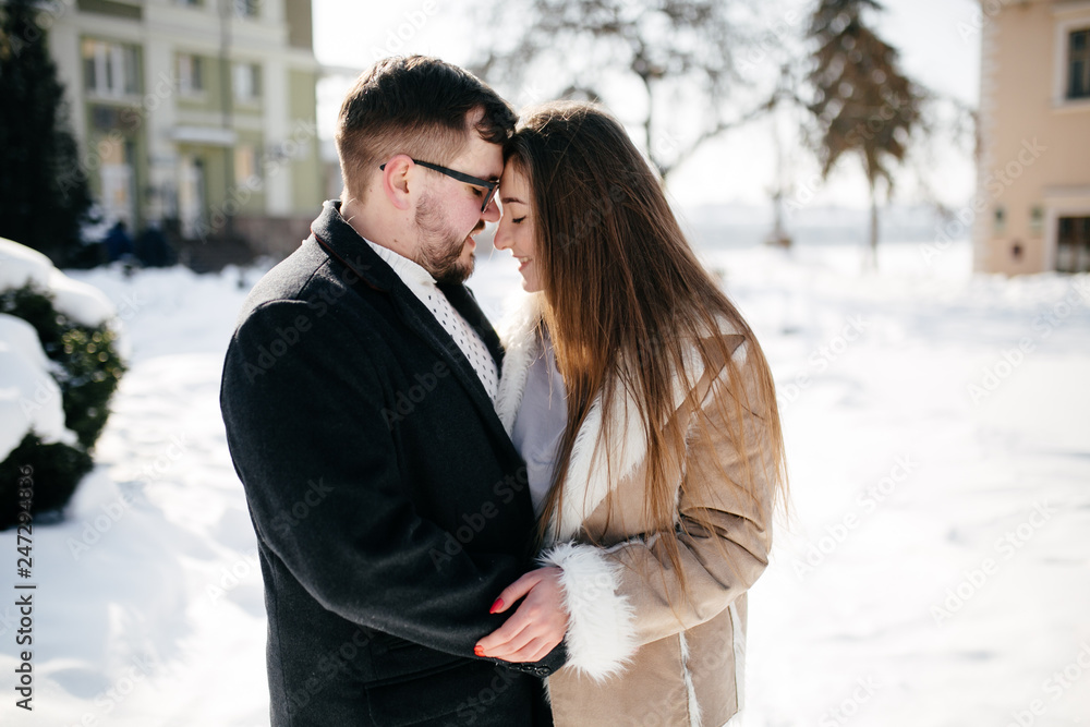 Young Beautiful Couple Taking Fun and Smiling Outdoors in Snowy Winter Young Beautiful Couple Taking Fun and Smiling Outdoors in Snowy Winter