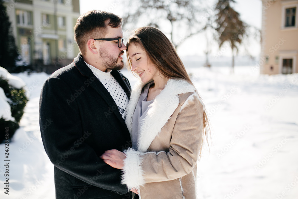 Young Beautiful Couple Taking Fun and Smiling Outdoors in Snowy Winter Young Beautiful Couple Taking Fun and Smiling Outdoors in Snowy Winter
