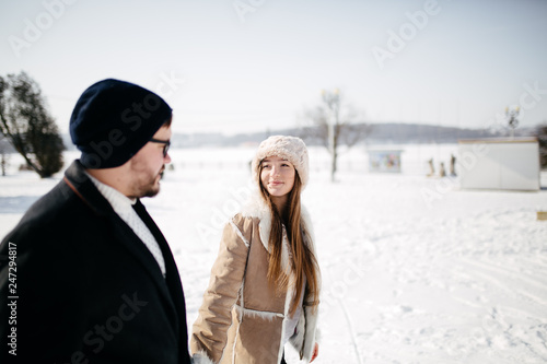 Young Beautiful Couple Taking Fun and Smiling Outdoors in Snowy Winter