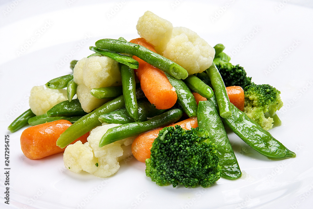 Steamed vegetables on white background. Cauliflower, peas, broccoli, carrots and asparagus beans. Steamed vegetables on white background. Cauliflower, peas, broccoli, carrots and asparagus beans.