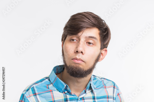 Process, problem, people concept - young man thinking about something on white background