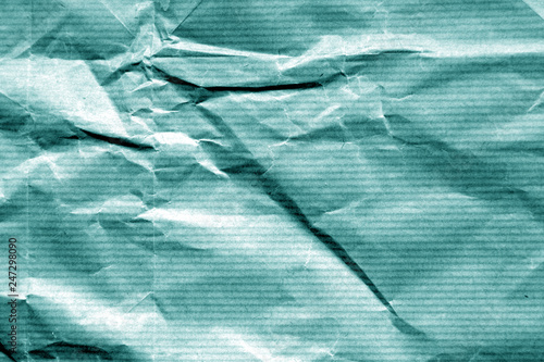 Crumpled sheet of paper in cyan color. photo