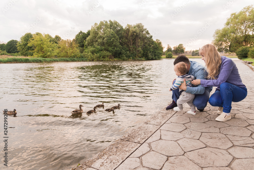 Family walk in the park. Family walks in the park. Man, woman and child in nature. Family walk in the park. Family walks in the park. Man, woman and child in nature.