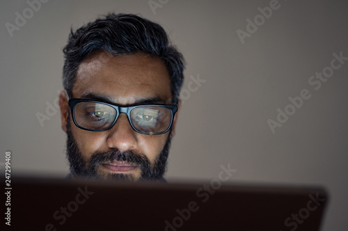 Man using laptop late night