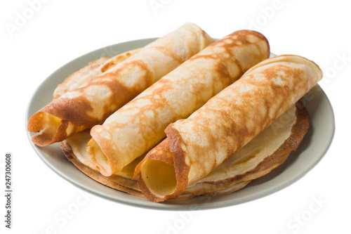 Thin pancakes on a plate isolated on a white background.