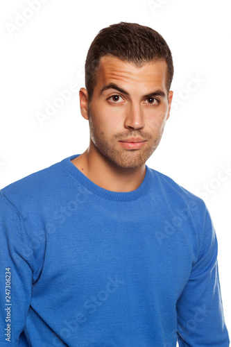 young man in blouse with skeptical look on white background © vladimirfloyd
