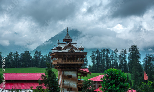 Kullu, Himachal Pradesh, India - August 04, 2018 : A Temple in Green meadows in himalayas, Great Himalayan National Park photo