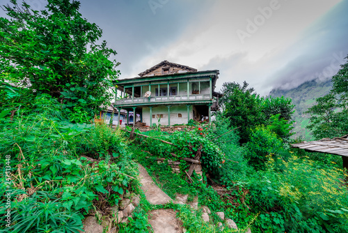 A traditional house in himalayas, sainj valley, kullu, himachal pradesh, india photo