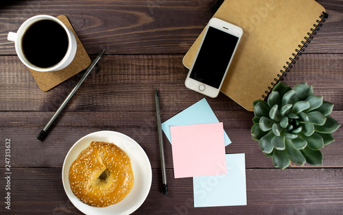 Flat lay, top view office table desk. Workspace with blank clip board, pencil, green leaf, and coffee cup on dark background. Сoncept for internet banners, marketing, promotion, business, startup