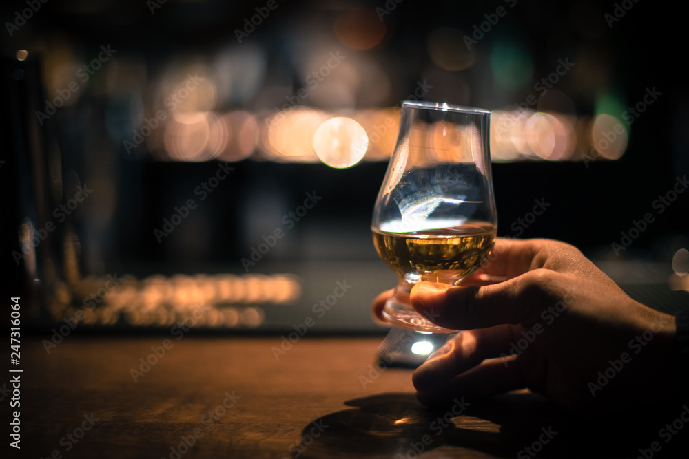 Hand holding a Glencairn single malt whisky glass
