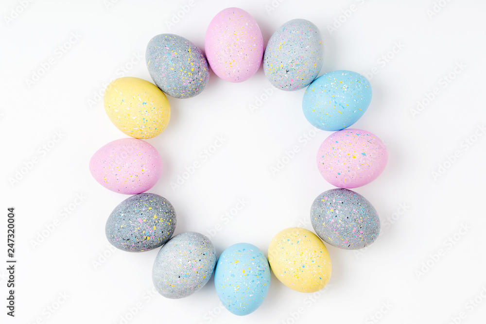 Stylish Frame of pale pink, blue and gray Easter eggs with copy space for text. Flat lay Stylish Frame of pale pink, blue and gray Easter eggs with copy space for text. Flat lay