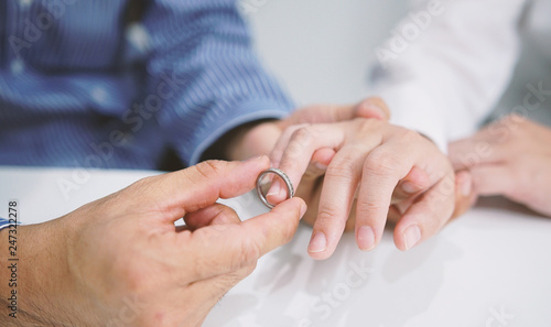 Groom gently wears the wedding ring. Valentine day, Wedding day