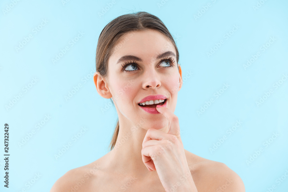 Thinking thoughtful young pretty woman posing isolated over blue wall background. Thinking thoughtful young pretty woman posing isolated over blue wall background.