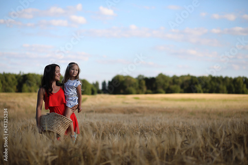 Summer landscape and a girl on nature walk in the countryside.