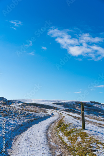 Snow covered Cleeve Hill, Cotwolds, Gloucestershire, UK on a sunny winters day photo