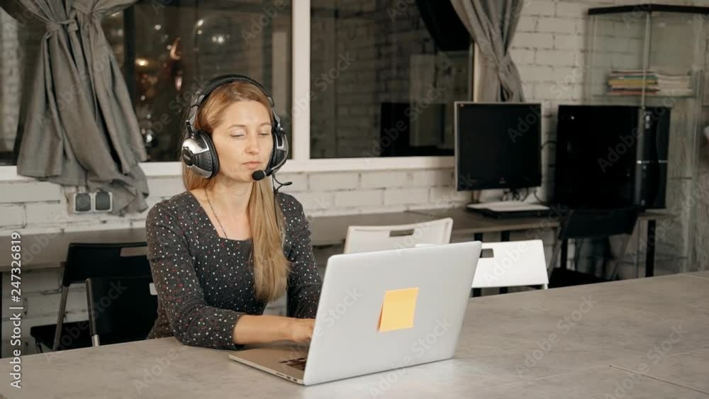Young woman participating in webinar on programming. Young woman participating in webinar on programming.