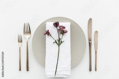 A dinner table decorated with purple flowers.